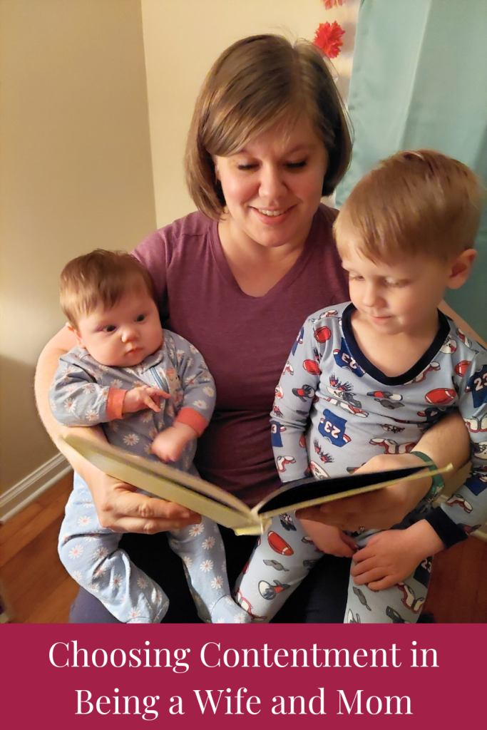 Author finding contentment in being a wife and mom reading to her kids in a rocking chair before bed