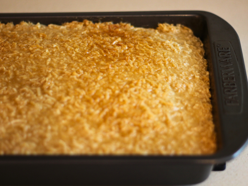 Image of lazy daisy cake in cake pan after frosting has been broiled and taken out of the oven