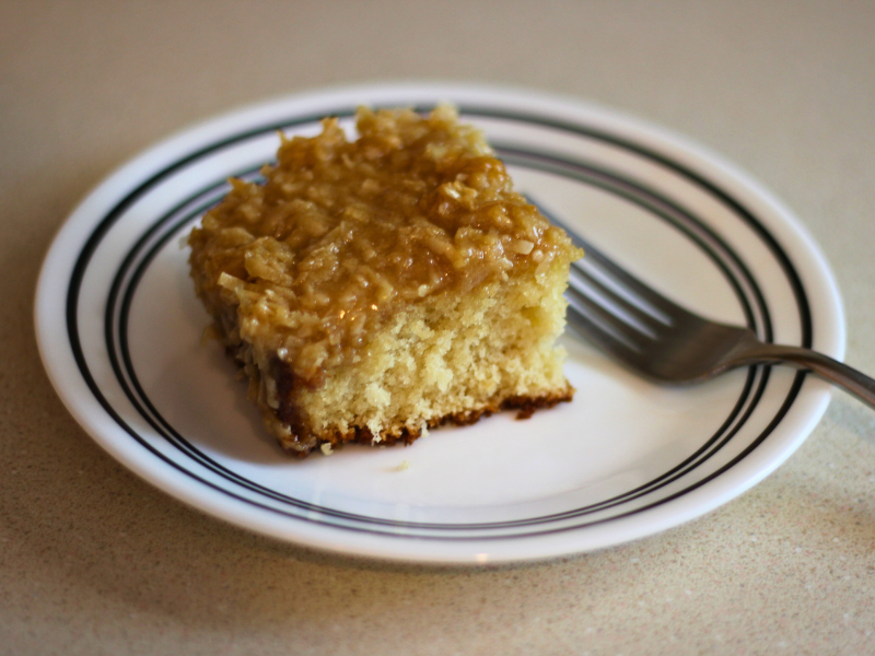 Zoomed in image of slice of lazy daisy cake on a plate and fork on the plate