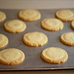 Image of old fashioned sugar cookies on a baking sheet, lightly brown, fresh from the oven